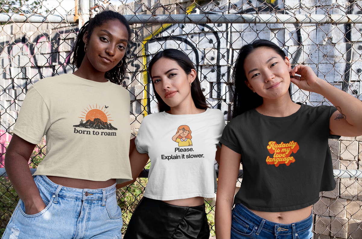 Three women of different backgrounds wearing Frontier Apparel graphic tees